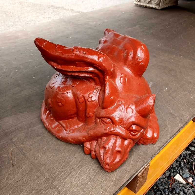 Curled dragon with folded wings in a glossy red finish